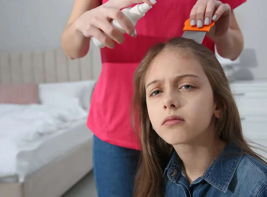 mother using over the counter lice treatment on her daughter to treat a lice infestation