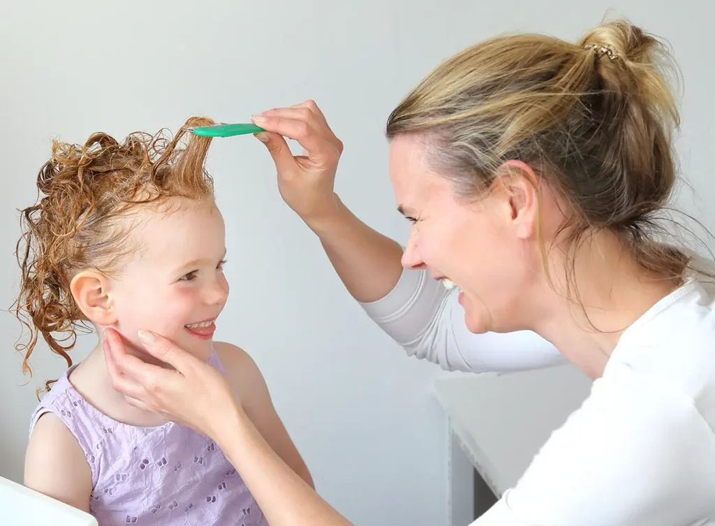 mother using diy lice treatment products at home