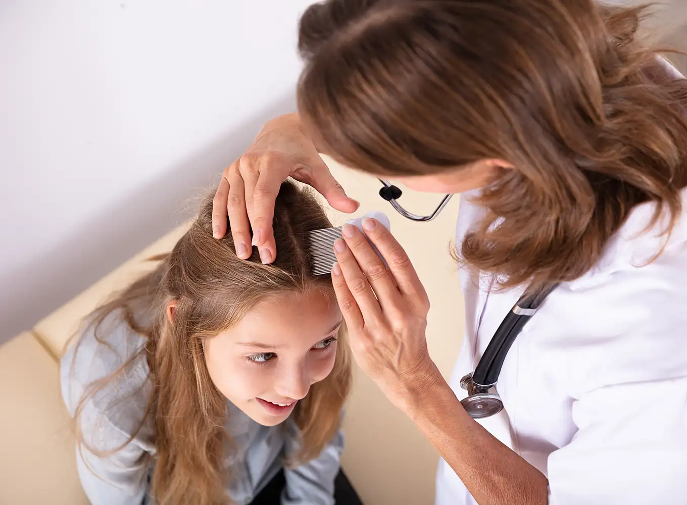 lice professional doctor checking a young girl's head for lice Alton IL